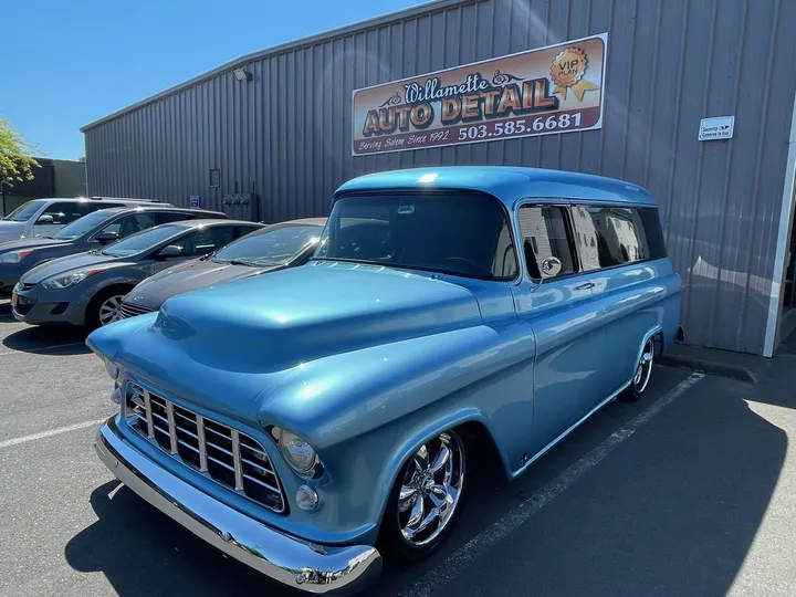 Light blue 1950s Chevy Suburban parked in front of the Lancaster Dr shop