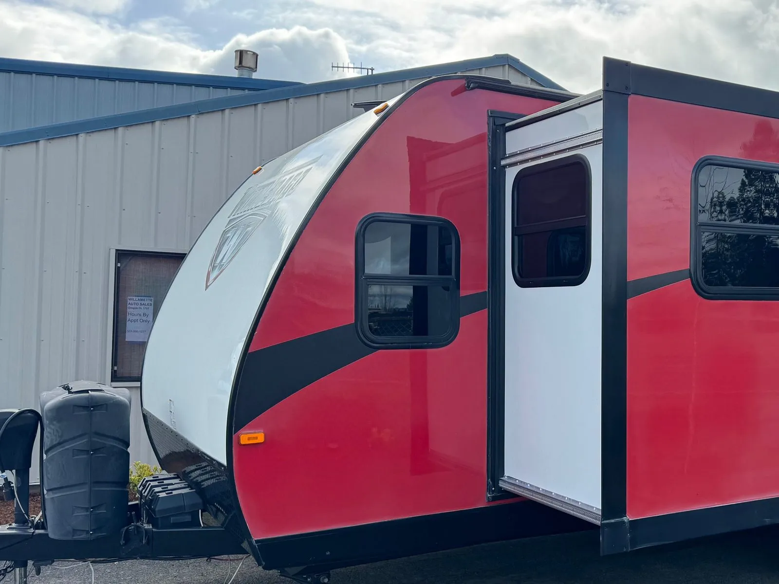 The same Minnie travel trailer back to red and black, with the slide-out extended